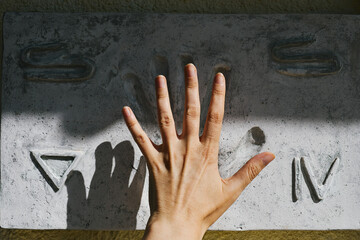 Woman hand touching an Egyptian hieroglyph on wall