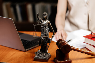 Concept of legal work, litigation. Justice and law concept. A lawyer works with a laptop in the...