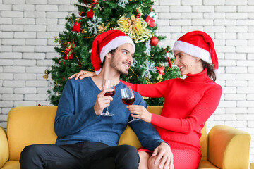 Couples are drinking wine celebrating the new year or chrismas, happy smiling with a glass of wine, happy time for both in long holidays