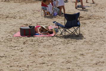Family enjoying a sunny afternoon at the beach with picnic and relaxation