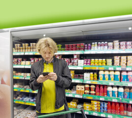 Shot of a young man shopping in a grocery store, using his smartphone to look up ingredients and prices wile choosing items at the supermarket.
