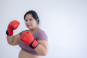 Portrait of chubby woman with boxing gloves