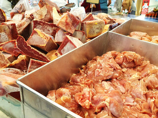 Fresh cuts of raw chicken and beef on display in supermarkets