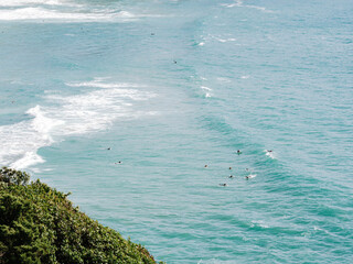 Few surfers lying on a surfboards waiting for a suitable wave alone in the ocean