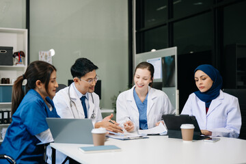 Fototapeta premium Medical, meeting and laptop for team in discussion, brainstorming and planning. Doctor, nurse on desk show diversity in collaboration, teamwork or workshop in hospital .