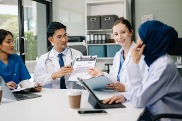 Medical, meeting and laptop for team in discussion, brainstorming and planning. Doctor, nurse on desk show diversity in collaboration, teamwork or workshop in hospital .