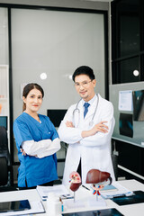 Fototapeta premium Successful team of medical doctors looking at camera and smiling while standin. Health, professional and people team in hospital