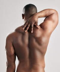 Back, stretching and man in studio with body health, pain or fitness and exercise for gym....
