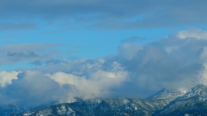 Nature Background. Snowy Mountain Top With A White Clouds Moving In With Blue Sky In The Background. Timelapse.