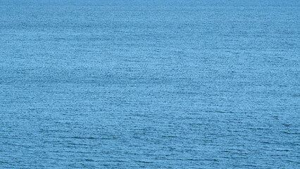 Beautiful Blue Water Of Ocean Or Sea With Waves. Blue Texture Of A Calm Water Surface. Still.