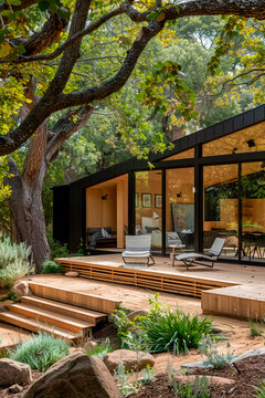 Luxurious modern house with large windows beautifully integrated into natural wooded surroundings