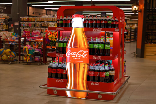 Minsk, Belarus. Apr 28, 2024. Retail display stand featuring rows of Coca-Cola bottles. Grocery store display stand stocked with Coca-Cola bottles.