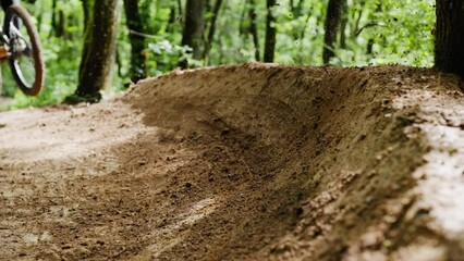 Mountain bike rider drifting thru the woods - Powered by Adobe