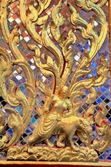 Native Thai style wood carving in the temple