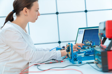 female student in a laboratory researching artificial intelligence for use in industrial devices
