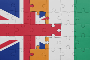 puzzle with the colourful national flag of cote divoire and flag of great britain.