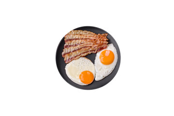 English breakfast with fried eggs, bacon, beans, tomatoes, spices and herbs