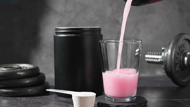 Protein shake and strawberry protein powder in a scoop, collagen, creatin, food supplement
