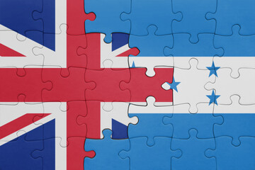 puzzle with the colourful national flag of honduras and flag of great britain.