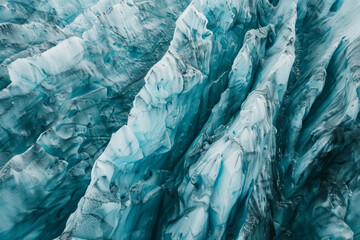 Aerial view of a glacier, capturing the intricate patterns and textures formed by the ice. Highlight the natural lines and subtle color variations to create a minimalist, abstract composition.