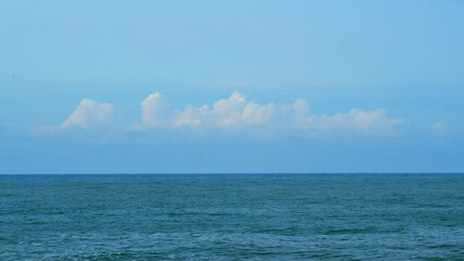 Quiet Seascape. Calming Waves Of The Sea Or Ocean During A Warm Sunny Day With A Blue Sky With...