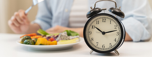 Intermittent fasting concept, Close-up on clock and people feeling hungry waiting time to eat...