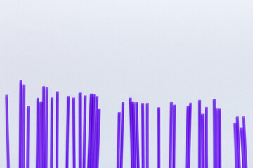 Heap of colorful plastic drinking straws on Colored background, flat lay. Copy Space for text