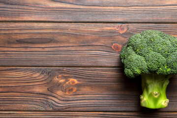 Top view fresh green broccoli vegetable on Colored background. Broccoli cabbage head Healthy or vegetarian food concept. Flat lay. Copy space