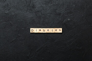 diabetes word written on wood block. diabetes text on table, concept