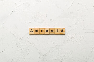 amnesia word written on wood block. amnesia text on table, concept