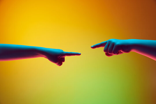 Kids hands gesturing against gradient green yellow background in neon light. Children hands reaching each other. Connection. Copy space for ad, text. Banner.