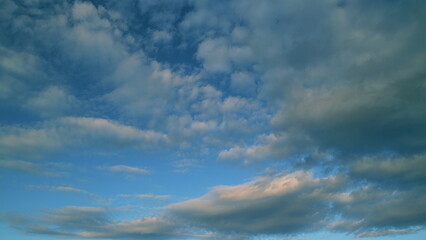 Cirrocumulus and cumulus on different layers cloudscape moved. Clearing day and good windy weather.