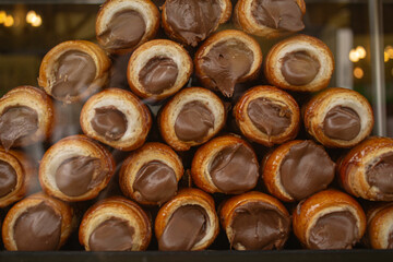 Italian sweet rolls with chocolate cream in Milan. Sicilian canolli rolls, сuisine in Italy. Coffee and sweets