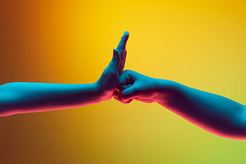 Child gesturing with hands against gradient green yellow background in neon light. Fist to palm....