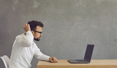 Side view headshot of serious puzzled confused caucasian businessman executive manager looking at...
