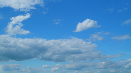 Clouds running across the blue sky. White puffy and fluffy Cirrocumulus clouds on blue sky. Time...