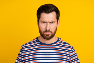 Portrait of gloomy serious brutal guy with stylish stubble wear striped t-shirt staring at you...