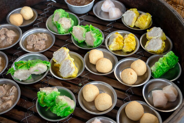 Bamboo basket of hot steamed a variety of dim sum.