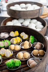 Various kinds of Chinese steamed buns and dumplings in bamboo baskets