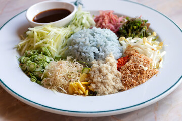 Spicy rice salad with vegetable. Thai southern spicy rice vegetable with dressing on white plate, Thai local food.