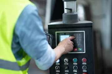 person controls automated machine in workshop