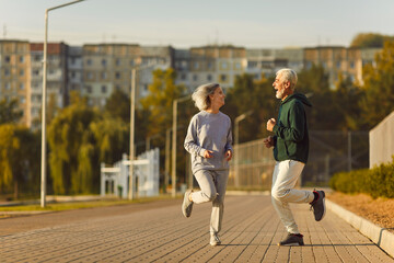 Happy old married couple learn physical vitality and longevity secret, do sport workout, have fun....