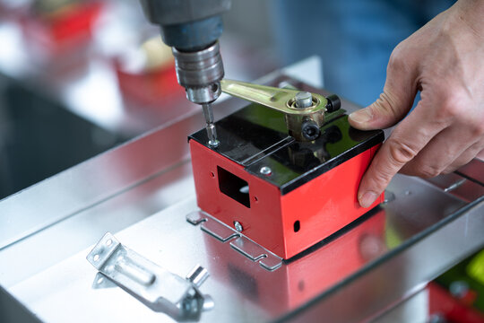 person using power screw in workshop