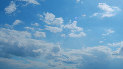 Building of a large white cloud in the blue sky. Clouds moving in blue sky with sun rays. Time...
