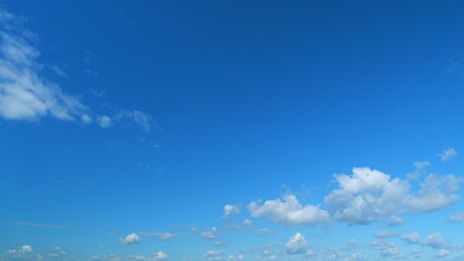 Puffy fluffy white clouds. Forming cloud moving with blue sunny, summer skies. Time lapse.