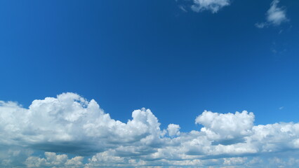 Dramatic Summer cloudscape. Blue sky white clouds. Changing cloudscape. Time lapse.