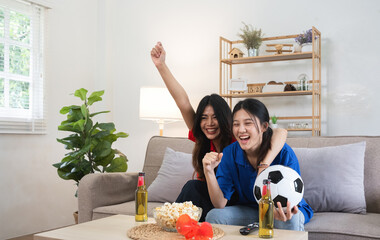 A lesbian couple cheers football and celebrate together for their favorite Euro football team. A...