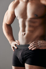Fitness, underwear and man with abs stomach in studio for bodybuilding, confidence and exercise....