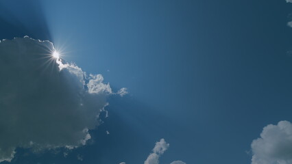 Beautiful blue sky with sunbeams and clouds. Clouds at blue sky background. Sunny cloudscape....