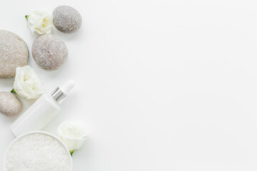 White roses and stones with skin care cosmetics products. Mock up, top view
